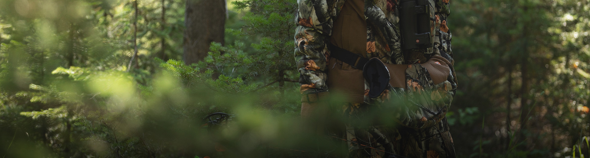 A man in the woods wearing HuntGuard gear.