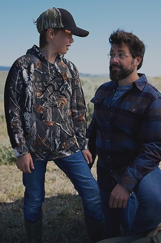 Father and son wearing Legendary Whitetails clothing