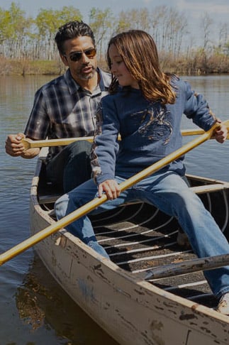 Father and son rowing in a canoe